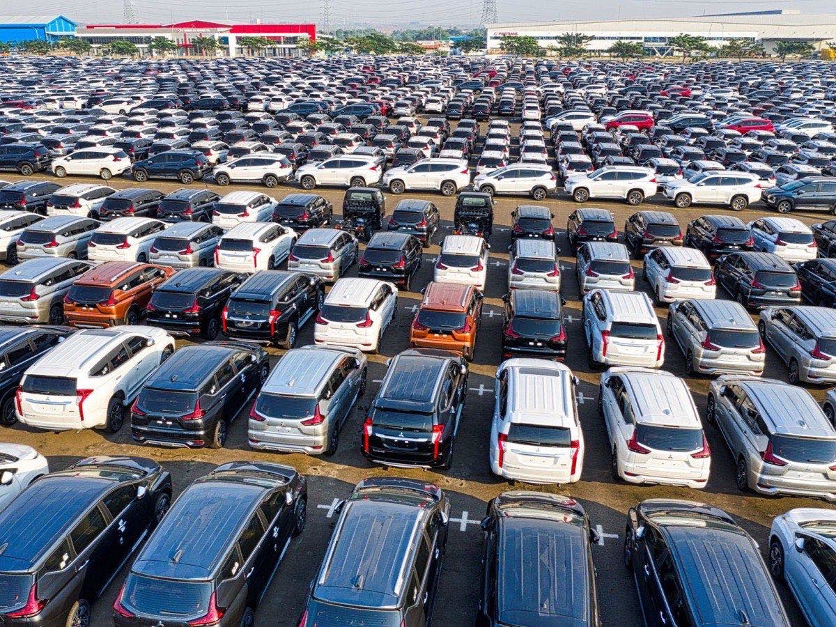 Rows of new cars on a dealer lot in daylight